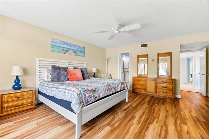 heated resort pool beside marina with lounge chairs and tropical landscaping