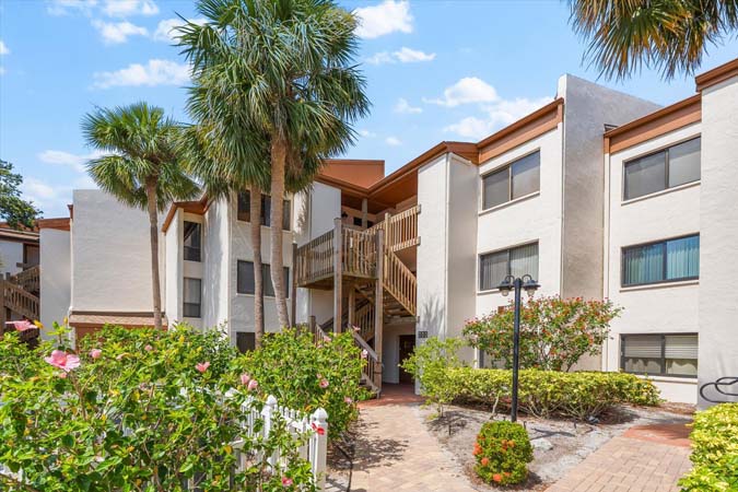 living room with balcony view of boats on the intracoastal at Bayview Beauty Siesta Key