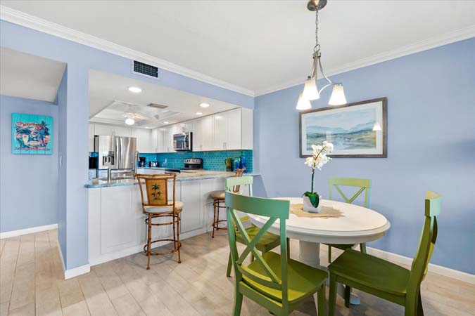 kitchen with bar seating and modern appliances inside Bayview Beauty Siesta Key