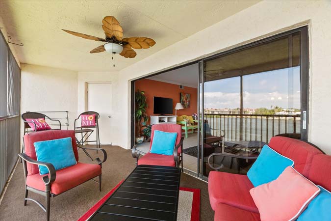 living room with balcony view of boats and intracoastal water at Bayview Beauty