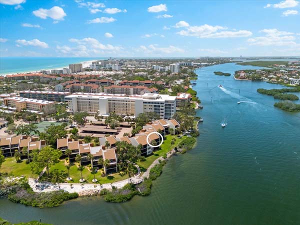 heated resort pool with lounge area beside marina at Siesta Key