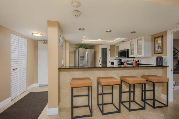 dining table and breakfast bar seating for six at Siesta Key condo