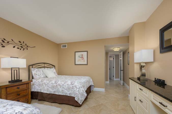 resort pool area with lounge chairs and umbrellas at Surf and Racquet Club