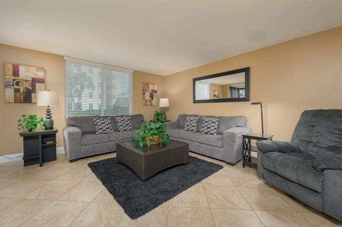 living room with enclosed lanai and partial Gulf view at Tower 0104 Siesta Key