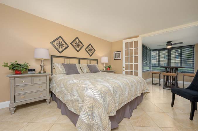 enclosed lanai with seating and soft Gulf breeze at Siesta Key condo